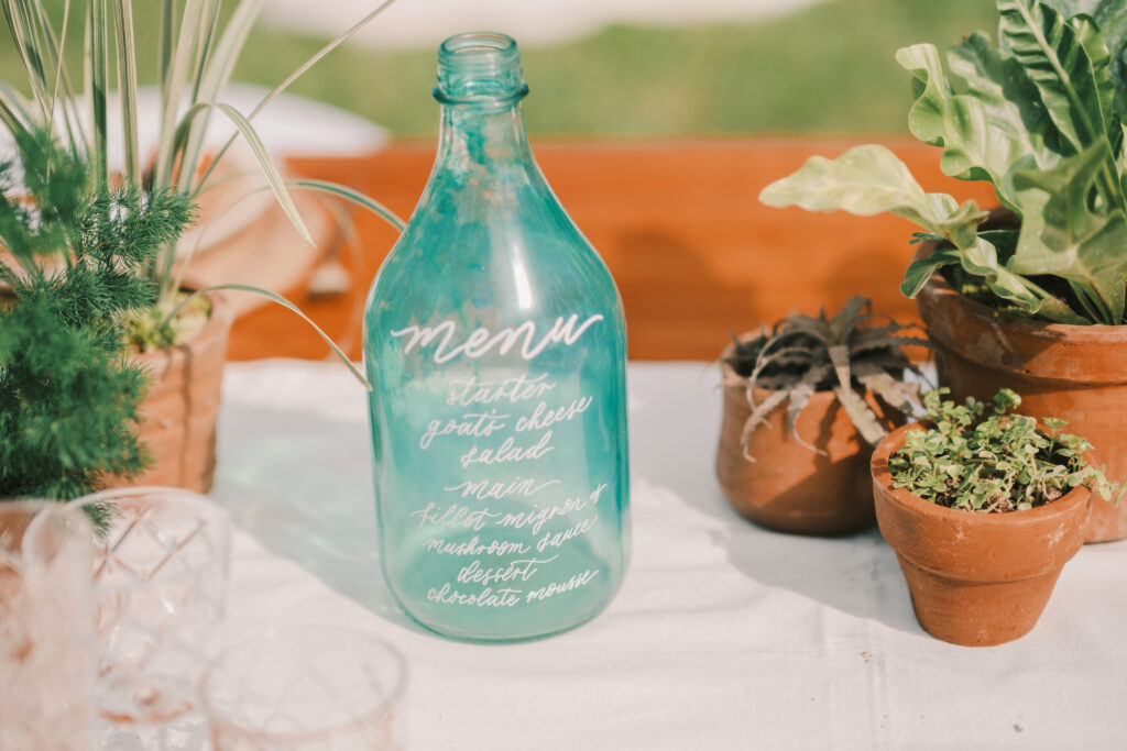 sustainable wedding calligraphy glass bottle menu